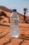 Plastic water bottle on a sandy desert background with clear blue sky.