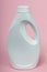Plastic white bottle for liquid laundry detergent, liquid softener, cleaning agent, bleach or fabric softener, on pink background