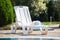 Plastic white sunbed near pool,