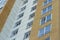 Plastic windows in a modern tiled brick high-rise house