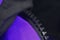 Plastic zipper on clothing, macro fragment, black and purple