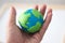 Plasticine globe in the hands , single focus