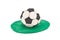 Plasticine soccer ball on grass