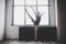 Plasticity slim woman dancing near window. Professional dancer enjoy dance. Lady Dancer Training Modern Ballet In Class.