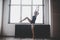 Plasticity slim woman dancing near window. Professional dancer enjoy dance. Lady Dancer Training Modern Ballet In Class.