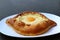 Plate of Adjarian Khachapuri, a Cheese and Egg Filled Traditional Georgian Bread