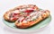 Plate of anchovies bread pizzas over white isolated background