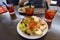 Plate with appetizer and three glass with drinks