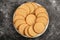 Plate of arrowroot biscuits on a rustic background.