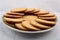 Plate of arrowroot biscuits on a rustic background.