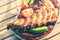 Plate with barbecue grilled spare ribs and sausages. Food background