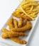 Plate of battered chicken strips with French fries