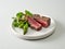 Plate of beef wagyu steak meat with herbs and asparagus