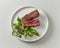 Plate of beef wagyu steak meat with herbs and asparagus