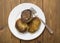 A plate with a Belarusian dish potato pancakes with meat filling. Wooden background, close-up