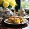 a plate of biscuits and teapot on a table