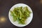 A plate of boiled green soybeans on table. A common side dish in Taiwanese restaurants.