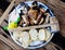 Plate with boiled legs and claws of brown crab with bread and dip on wooden table