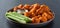 Plate of boneless chicken wings with buffalo sauce and celery sticks