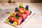 Plate with bright canapes of watermelon, grapes, mint