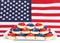 Plate of bright patriotic cookies in front of American flag