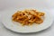 A plate of bucatini amatriciana with a drop of pecorino cheese