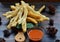 A plate of Cakwe or Cakue with chilli sauce at wooden table. Cakwe is a popular traditional snack from Chinese and indonesia.