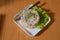 On the plate capital salad.Mayonnaise salad. Food background - salad olivier close-up. Green peas, cucumber, potatoes, sausage,