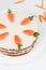 Plate with carrot sponge cake and little orange