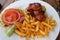 A plate of cheese burger with bacon, tomatos, onions and french fries
