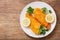 Plate of chicken schnitzel on a wooden background