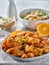 Plate of chinese orange chicken with green onion garnish