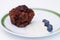 Plate of chocolate muffin, blueberries and soy cream