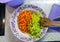 Plate with chopped  frying carrots and green pepers  as ingredients for vegetable stew.