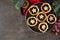 Plate of Christmas mincemeat tarts, overhead view table scene over a dark background.