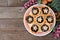 Plate of Christmas mincemeat tarts. Table scene over dark wood.