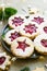 Plate with Christmas or New Year shortcrust cookies with red jam. Traditional festive Austrian cookies with jam. Linzer cookies.