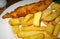 A plate of chunky chips and a piece of battered fish