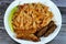 A plate of classic pasta penne macaroni with tomato sauce, Egyptian classic homemade sausage of deep fried stuffed mumbar which is