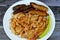 A plate of classic pasta penne macaroni with tomato sauce, Egyptian classic homemade sausage of deep fried stuffed mumbar which is