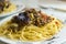 plate with cooked hot pasta with meat sauce and basil, food, Italian dish,