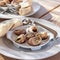 Plate with cooked snails in a rustic restaurant closeup