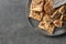 Plate with cookies and cereal bars on grey background