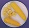 A plate with corn on a purple background