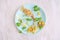 Plate with creative and simple breakfast  for children on table. pancakes, corn, cheese, herbs, olives