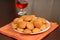 A plate of crisp Amaretti cookies with snifter of Amaretto in ba