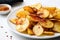 plate of crispy, salty potatoes chips with spicy seasoning