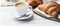 Plate of Croissants Next to Cup of Coffee, Delicious Breakfast Pairing for a Cozy Morning