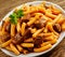 Plate of cubed grilled beef with rigatoni pasta