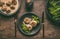 Plate with cutlery and low carb dieting meal: meat balls and blanched broccoli on wooden table background